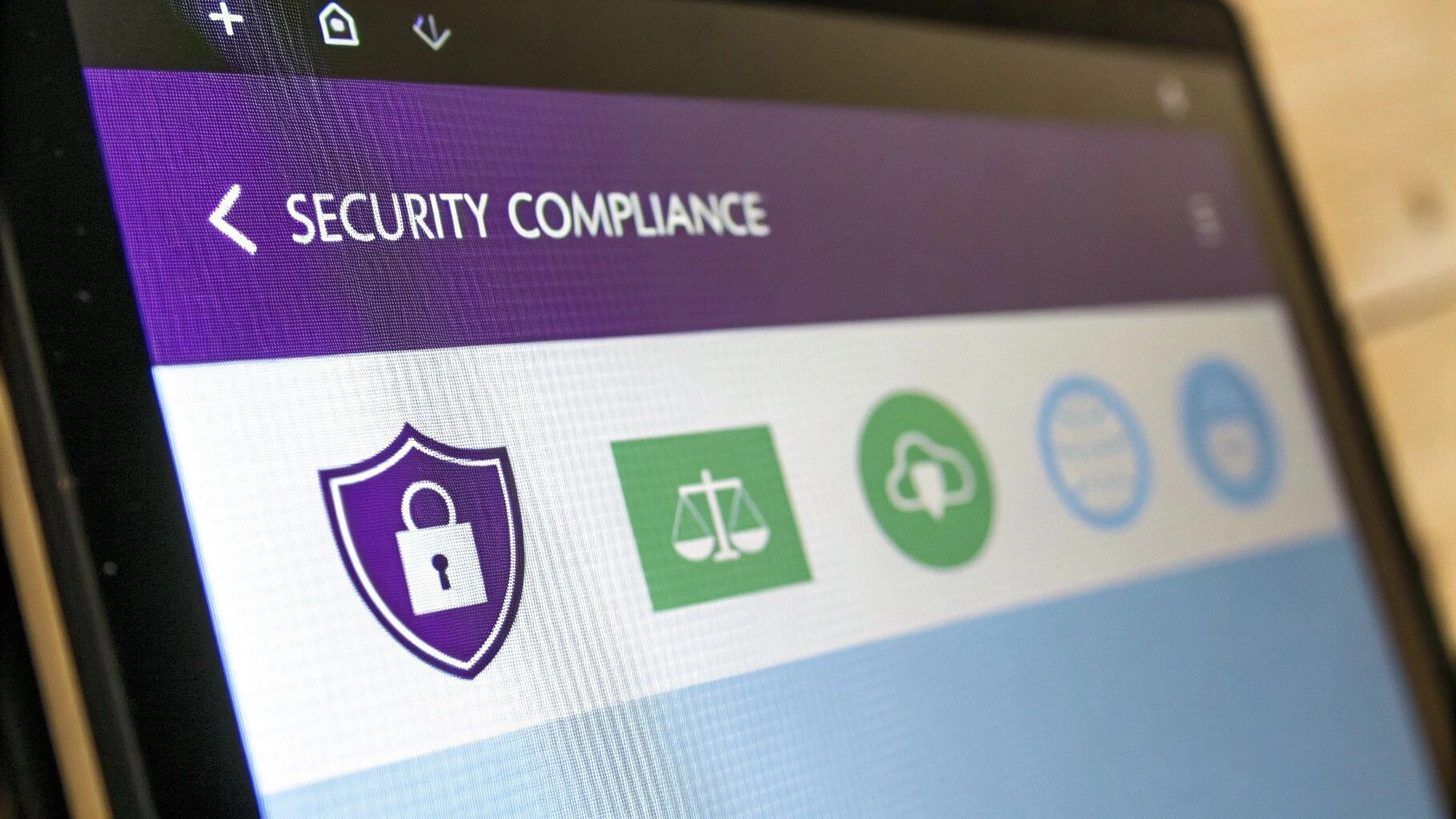 An abstract image representing digital security, with icons for shields, locks, and data protection, symbolising a comprehensive security and compliance framework.